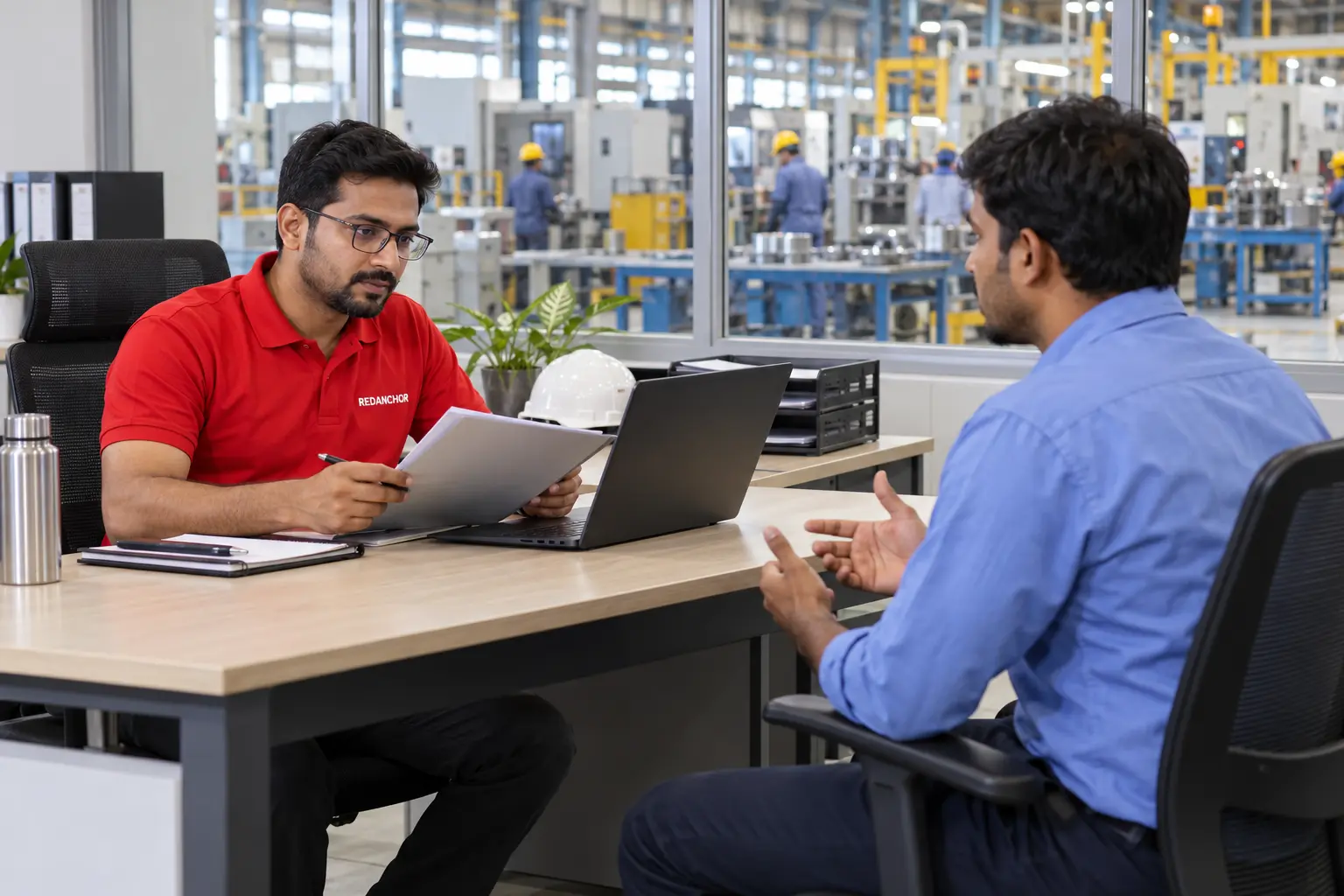 REDANCHOR HR recruiter conducting a screening interview with an adult technical candidate in an Indian facility office